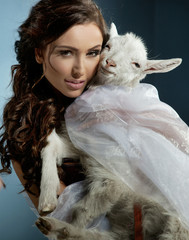 Cute brunette holding a little goat