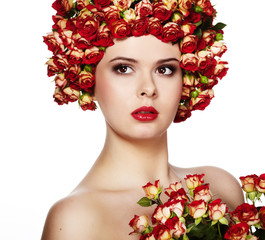 Portrait of young beautiful woman with rose in hair, on white ba