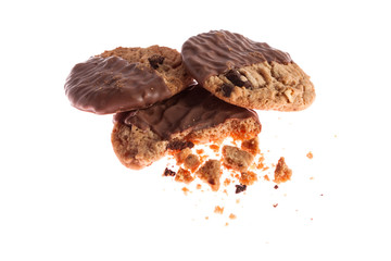 Chocolate chip cookies with bite missing on a white background