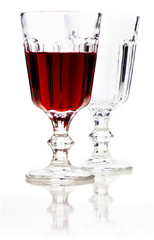 Glass of red wine and empty glass.