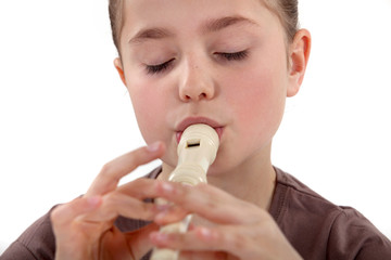 Little girl playing the recorder