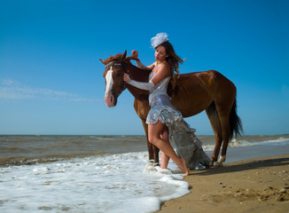 Girl and horse at the beach