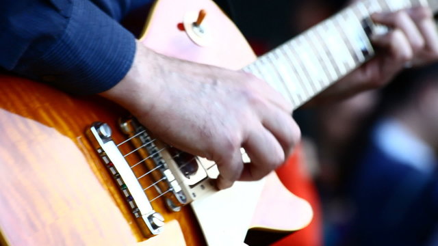 A guitarist in live action at a concert
