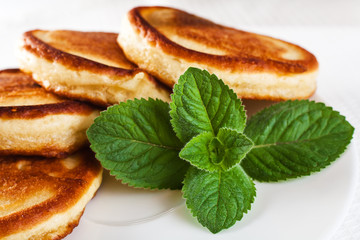 pancakes with sour cream and mint leaf