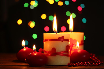 Beautiful candles on wooden table on bright background