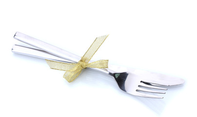 Silver fork and knife tied with ribbon isolated on white