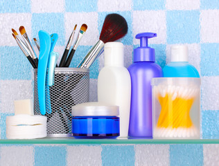 Shelf with cosmetics and toiletries in bathroom