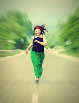 happy, cheerful girl running down the road