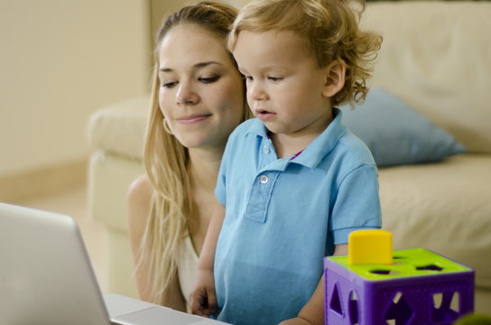 Mom Showing Something To Her Son On A Computer