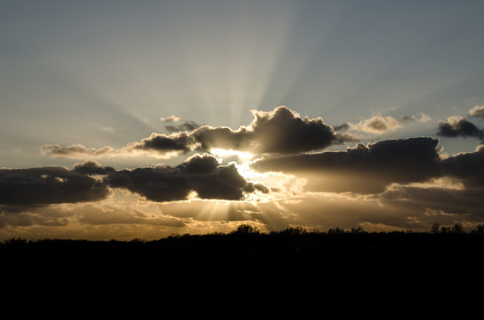 sun behind the clouds