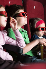 Fototapeta premium Three friends eating popcorn