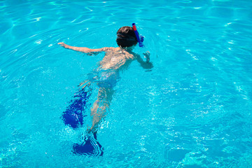Little boy diving under water