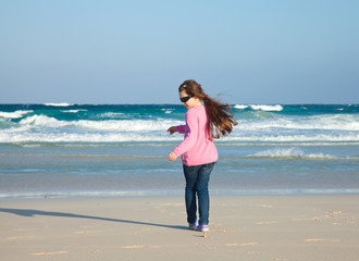 small girl on a evening beach