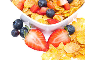 Cornflakes with fresh fruits on white
