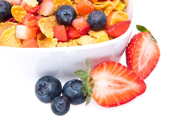 Cornflakes with fresh fruits on white