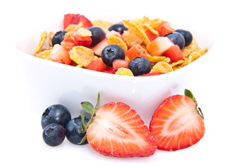 Cornflakes with fresh fruits on white