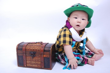 Fototapeta premium Baby boy sitting with a box