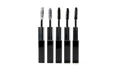 Isolated black mascara with brush laying on white background