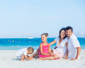 Family of four on tropical beach