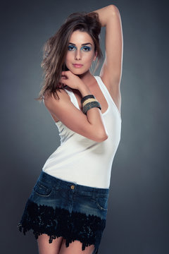 young woman in jeans skirt and white velt