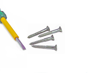 close up of steel screws and screw driver arranged on white
