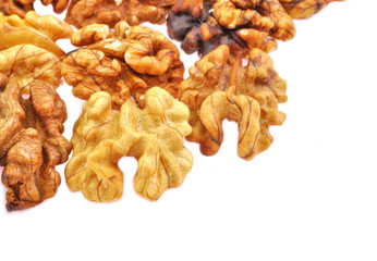 close up of edible portion of walnut arranged on white