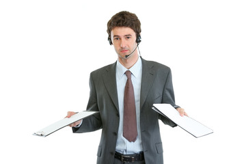 Business operator with headset confused in pile documents