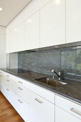 modern house with hardwood floor, view of the kitchen