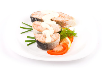 Boiled tasty salmon with vegetable on a white background