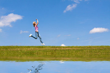 Woman jumps on the meadow
