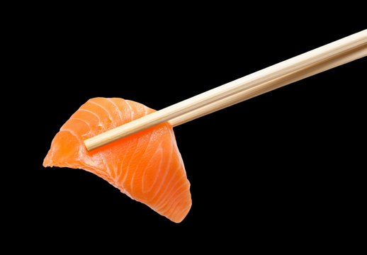 Chopsticks with sliced raw salmon