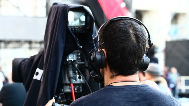 Cameraman with camera on stage at concert