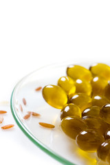 transparent pills of vitamin E on dish and rice