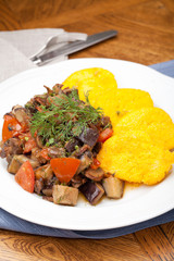 Polenta slices with vegetable stew