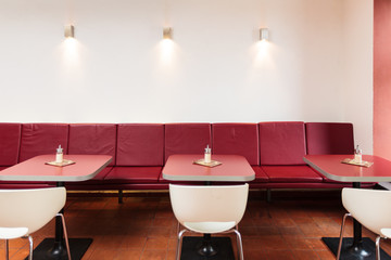 Empty seats in red colored restaurant