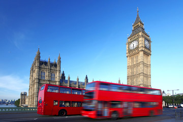 Big Ben with red city buses in London, UK