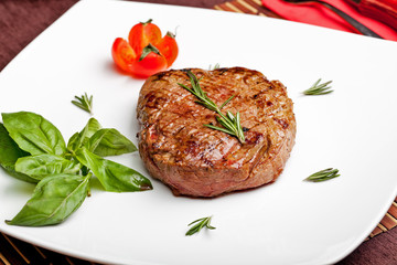 Grilled steak on a white plate