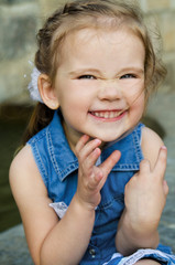 Portrait of smiling little girl in dress outdoor