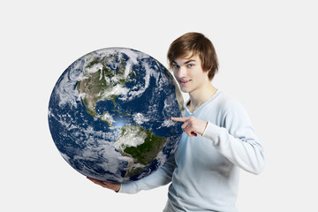 Handsome young man pointing and holding the planet earth