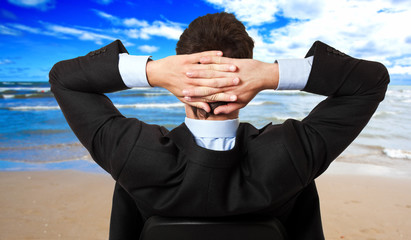 Businessman looking at the sea: relax concept
