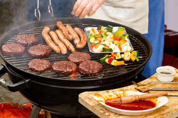 Burgers and sausages on barbecue
