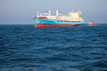 Fototapeta premium Container ship assist by a tugboat towards the port of Gdansk.