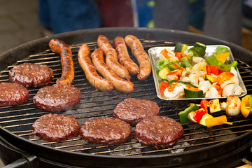 Burgers and sausages on barbecue