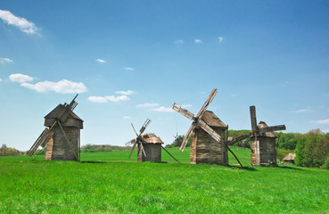Fototapeta na wymiar ancient windmills in field