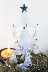 A small glass christmas tree with candle