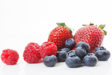 Fototapeta na wymiar Raspberries, blueberries and strawberries. Delicious fruits.
