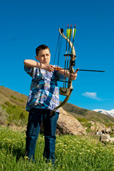 A young boy shooting archery