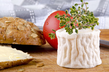 goat cheese with thyme on a wooden board