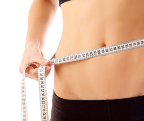 woman measure her waist belly by metre-stick