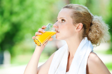 Woman drinking juice after exercise